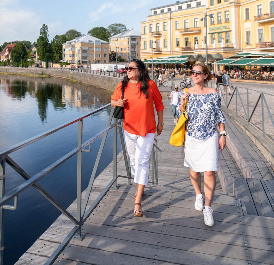 kvinnor som går längs älven