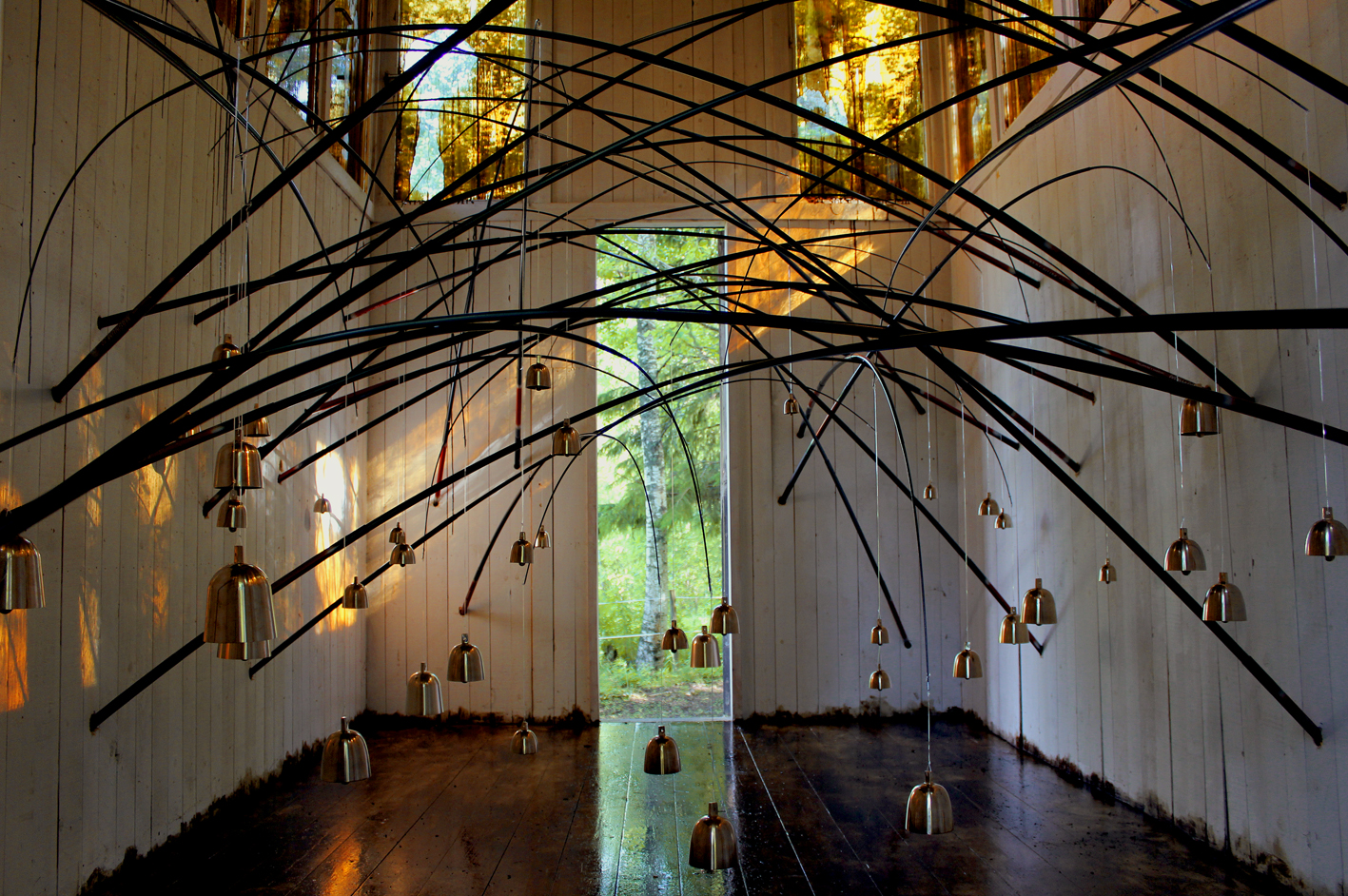 An artwork with bells in a wooden house